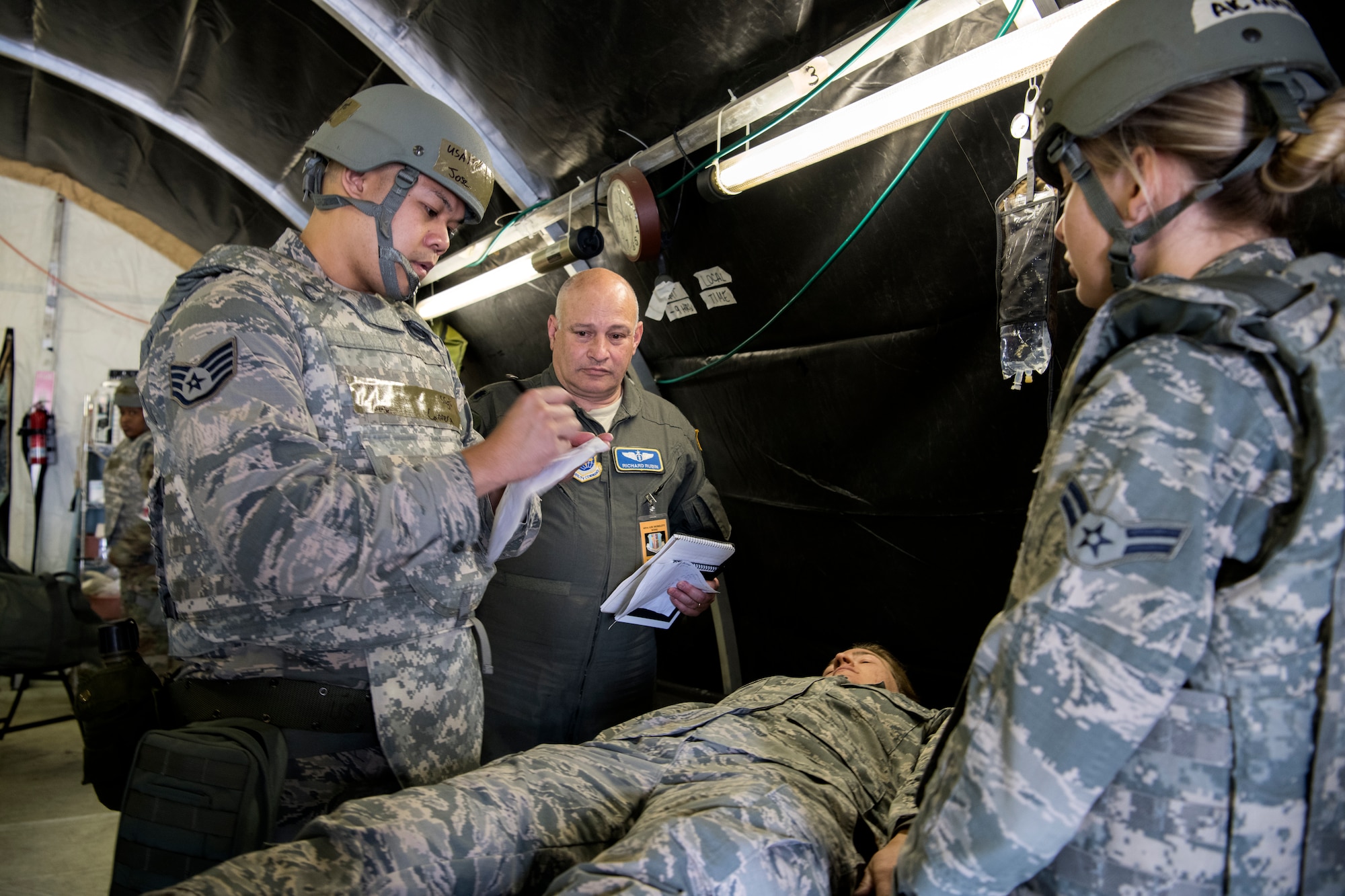 Staff Sgt. Jose Cabrera, 349th Aerospace Medical Squadron medical technician, writes a patients vitals down as he is inspected by Lt. Col. Richard Rubin, 60th AMDS deputy chief, during Golden Thunder 19-02 at Travis Air Force Base, California, on May 6, 2019.