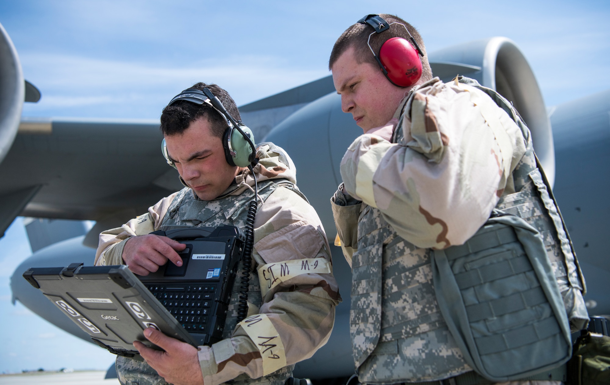 Senior Airman Justin Woodruff and Airman 1st Class Christopher Cifers, 860th Aircraft Maintenance Squadron crew chiefs, look over inspection codes for a C-17 Globemaster III during Golden Thunder 19-02, at Travis Air Force Base, California, on May 6, 2019.