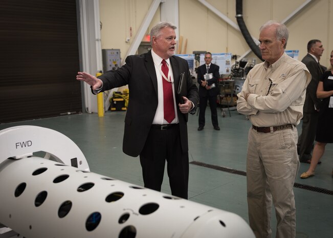 John Hutton, Naval Surface Warfare Center Panama City (NSWC PCD) Littoral Mine Warfare Systems department head, discusses one of the 150 projects currently being developed at NSWC PCD during a tour with the Secretary of the Navy, Richard V. Spencer, May 10. NSWC PCD is ensuring warfighting dominance in the littoral battlespace. U.S. Navy photo by Anthony Powers