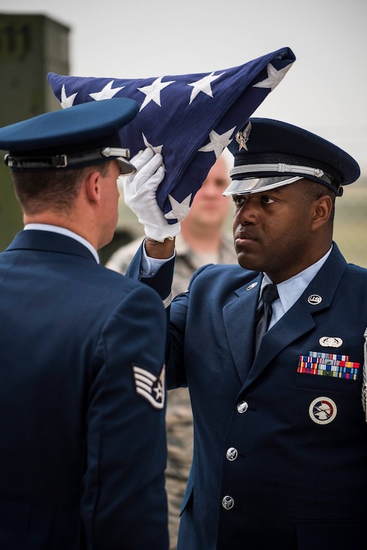 The Mountain Home Air Force Base honor guard conducts a ceremony April 5, 2019 at their ceremonial unit. The flag is presented to a retiree at a retirement ceremony. (U.S. Air Force photo by Airman First Class Janae Capuno)