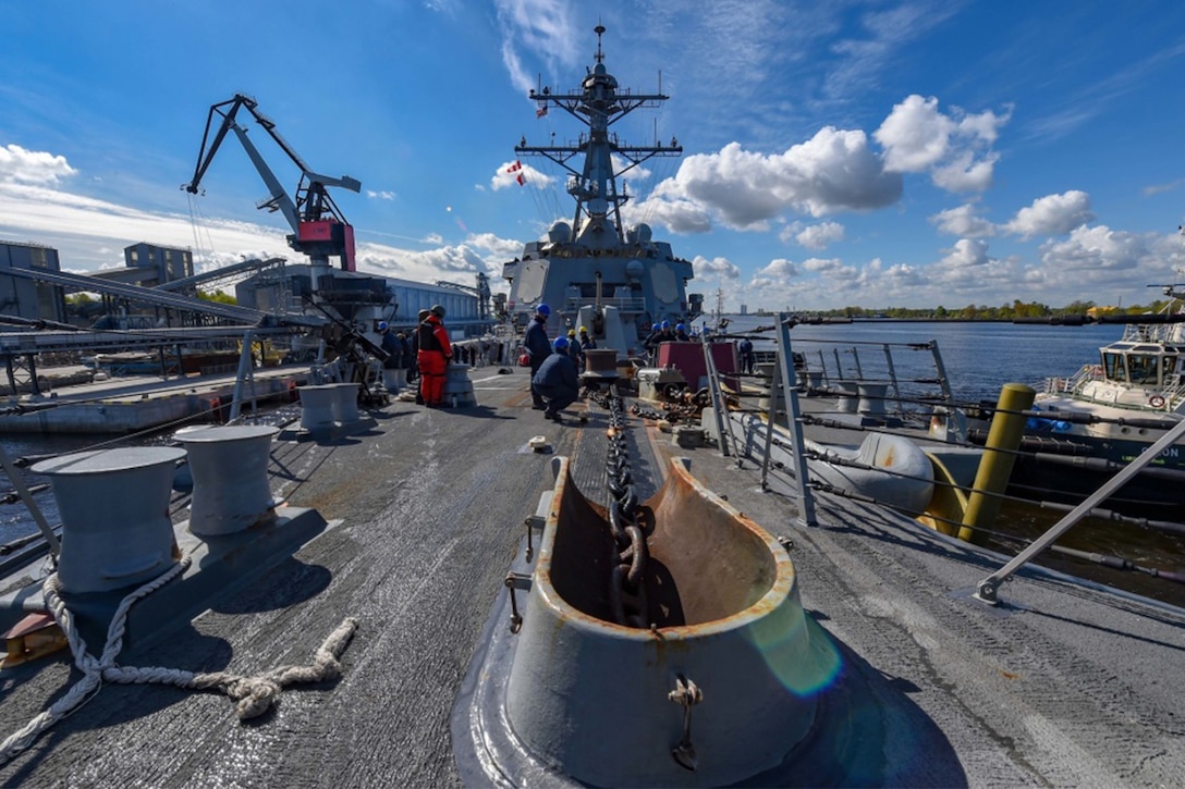 Sailors work on a ship’s deck.