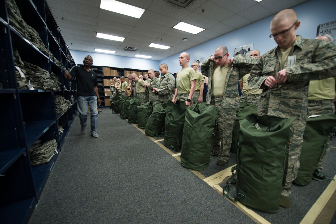 Cecil Harvey, 502d Logistics Readiness Squadron lead supply technician, helps with the sizing of uniforms during initial clothing issue, Feb. 13, 2019, at Joint Base San Antonio-Lackland, Texas. The 502d LRS is responsible for issuing and fitting individual uniforms for more than 1,600 BMT trainees weekly. (U.S. Air Force photo by Sarayuth Pinthong)