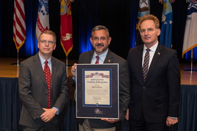 The Honorable David L. Norquist, performing the duties of The Deputy of the Secretary of Defense, and Sajeel S. Ahmed, Acting Director of Administration and Organizational Policy Office of the Chief Managment Officer, host the Spirit of Service Ceremony at the Pentagon in Arlington, Va., May 9, 2019. Mark Brown, the head of the U.S. Marine Corps’ installation emergency management program, was recognized for his outstanding job performance and humanitarian work. (U.S. Army photo by Spc. Zachery Perkins)