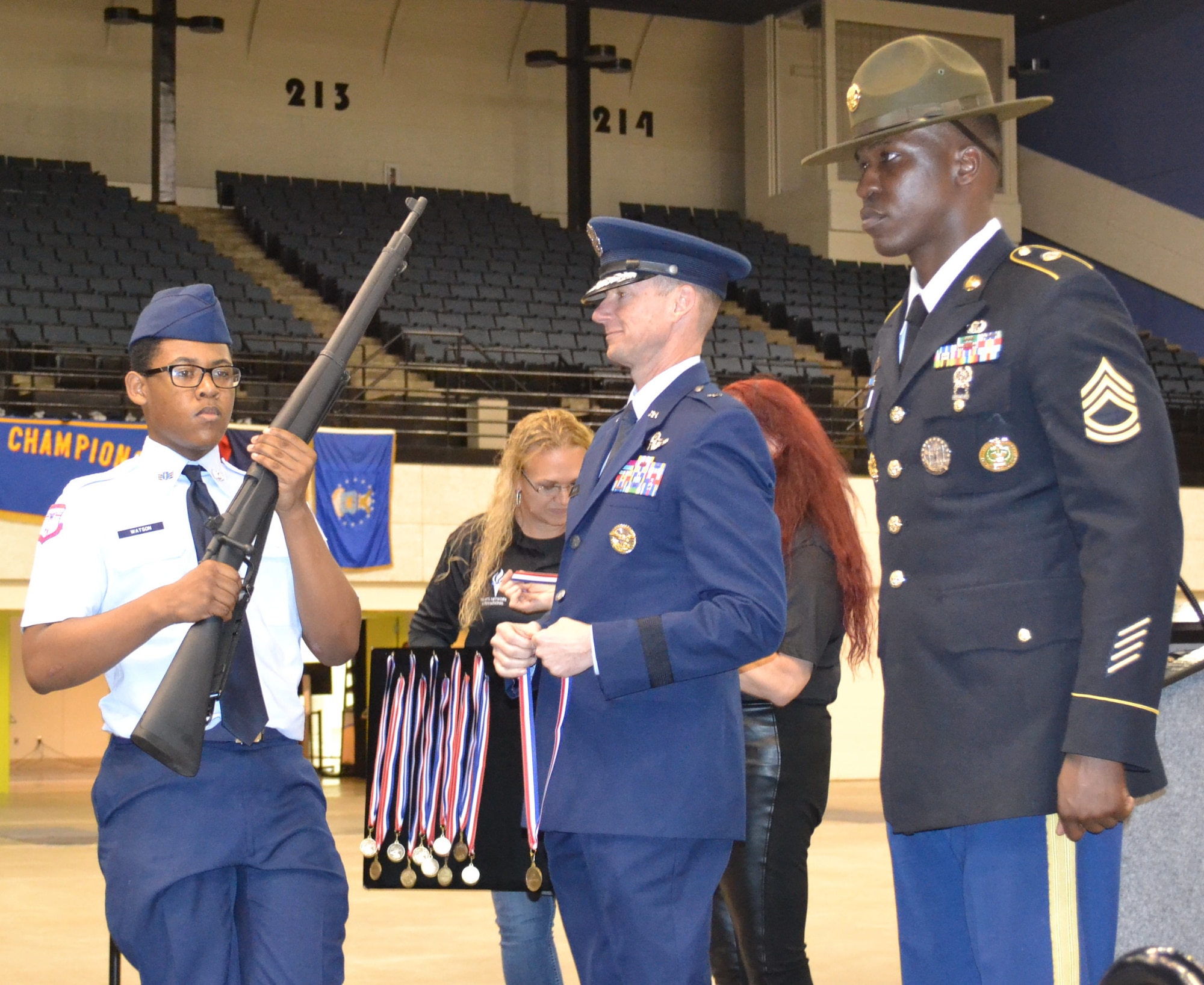 U.S. Air Force Brig. Gen. Christopher Niemi, Holm Center commander from Maxwell Air Force Base, Ala.,  presents a medal to Cadet Isaiah Watson, West Aurora High School, Ill., for his second place win in the Demilitarized Armed Knockout Competition at the National High School Drill Team Competition, May 3-5 2019, at Daytona Beach, Fla.  Cadet Watson beat out more than 500 cadets in a mass formation competition where cadets get ‘knocked out’ for not executing commands perfectly.