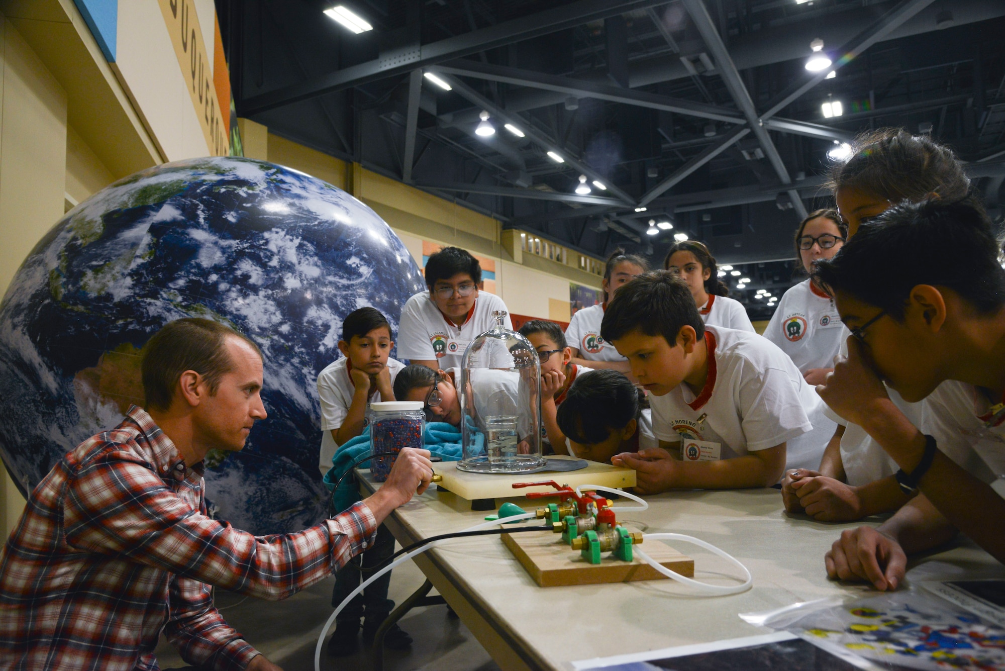 Zak Wilson, a mechanical engineer with Sandia National Laboratories, conducts experiments with air pressure for students during the 2019 Mission to Mars at the Albuquerque Convention Center May 10. The Air Force Research Laboratory New Mexico’s STEM Outreach branch put on the mission, with more than 1,300 fifth-grade students from schools across the Albuquerque area and New Mexico taking part in the massive science and engineering experiment. (U.S. Air Force photo by Jim Fisher)