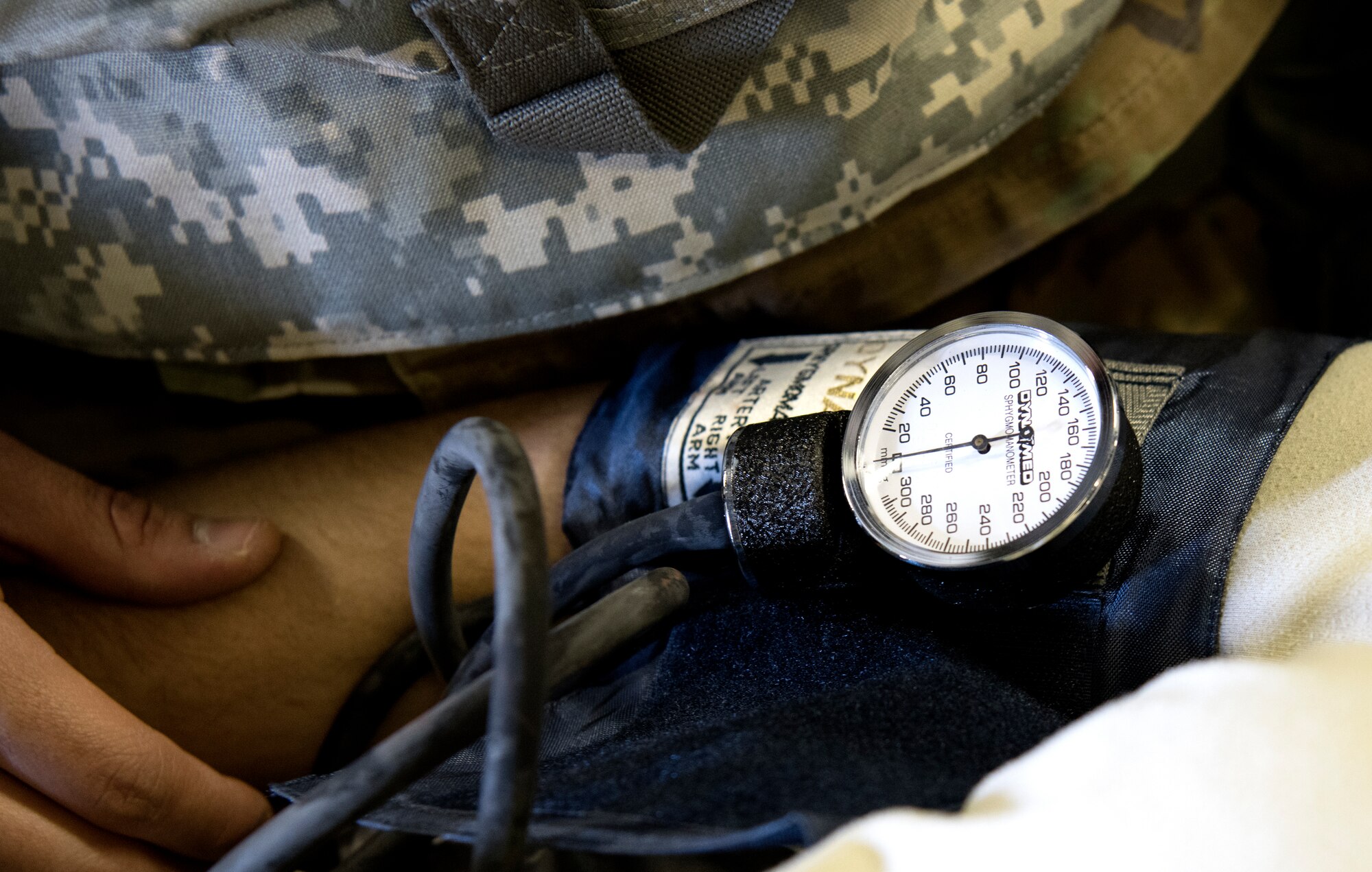 A medical technician checks the blood pressure on a patient during Golden Thunder 19-02 at Travis Air Force Base, California, May 6, 2019. This joint exercise between the 349th Air Mobility Wing and 60th AMW was designed to assess AEF deployment, employment, and redeployment processes, evaluate wartime readiness, and identify resource-to-requirement gaps, to accurately report on the ability to meet mission directives and designed operational capability requirements. (U.S. Air Force Photo by Tech. Sgt. Daniel Phelps)