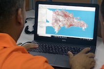 A communications operator with the Dominican Republic Ministry of Public Works and Communications creates virtual maps that depict weather effects like flooding in various regions of the Dominican Republic at the Emergency Operations Center in Santo Domingo, May 8, 2019.