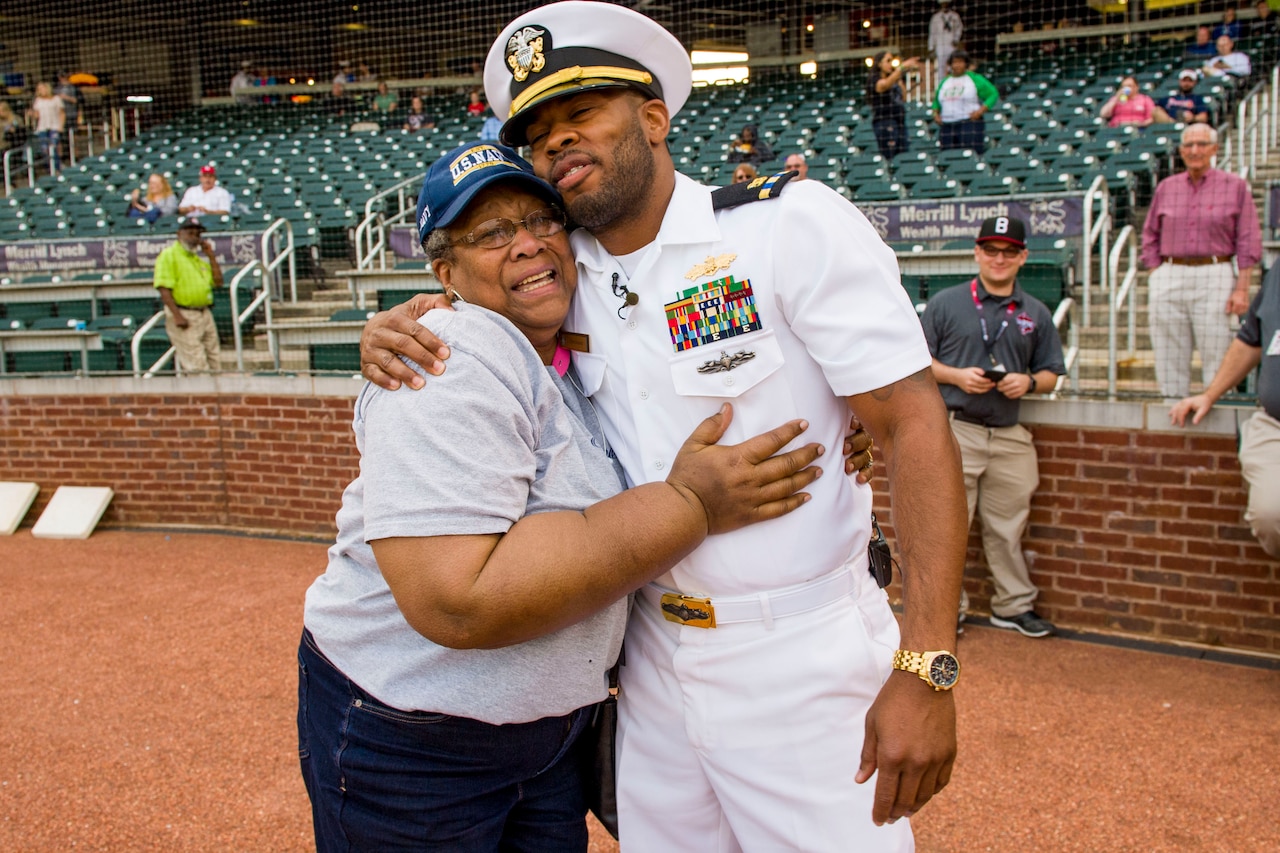 Sailor surprises mother at a baseball game.