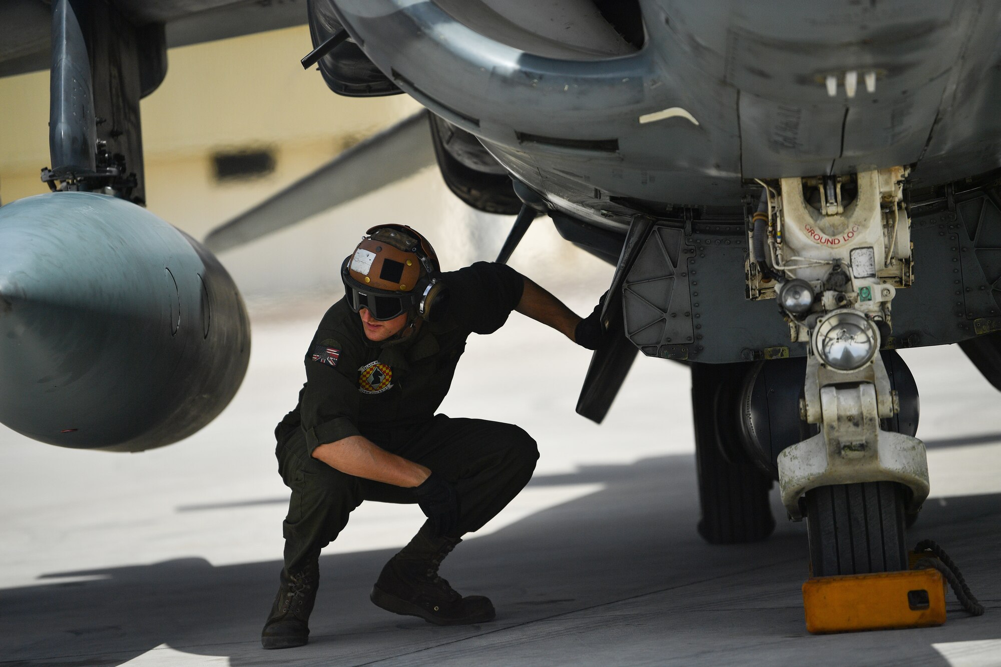 A U.S. Marine conducts pre-flight checks on an AV-8B Harrier II during Desert Flag 19-2 in Southwest Asia, April 28, 2019. Desert Flag is designed to exercise combined Air Forces in military operations to enhance competence and strengthen military-to-military relationships and regional security.