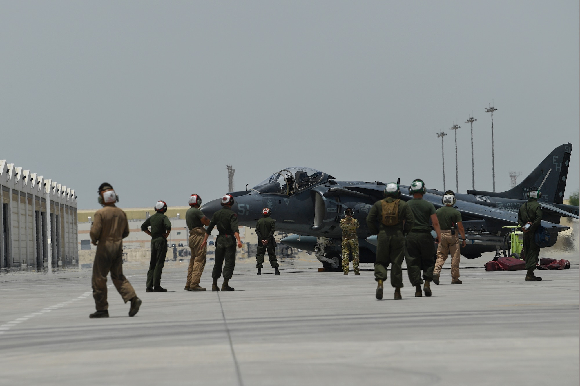 U.S. Marines observe as an AV-8B Harrier II is prepared to take off during Desert Flag 19-2 in Southwest Asia, April 28, 2019. Desert Flag is designed to exercise combined Air Forces in military operations to enhance competence and strengthen military-to-military relationships and regional security.