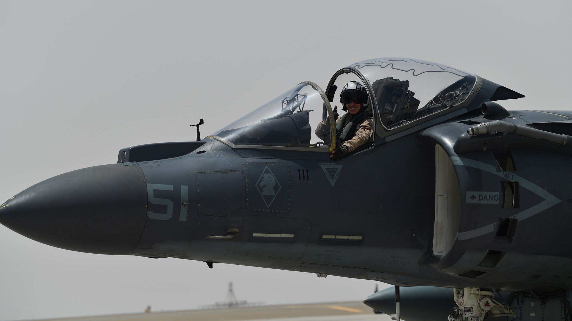 A U.S. Marine waves while taxiing in an AV-8B Harrier II during Desert Flag 19-2 in Southwest Asia, April 28, 2019. Desert Flag is designed to exercise combined Air Forces in military operations to enhance competence and strengthen military-to-military relationships and regional security.