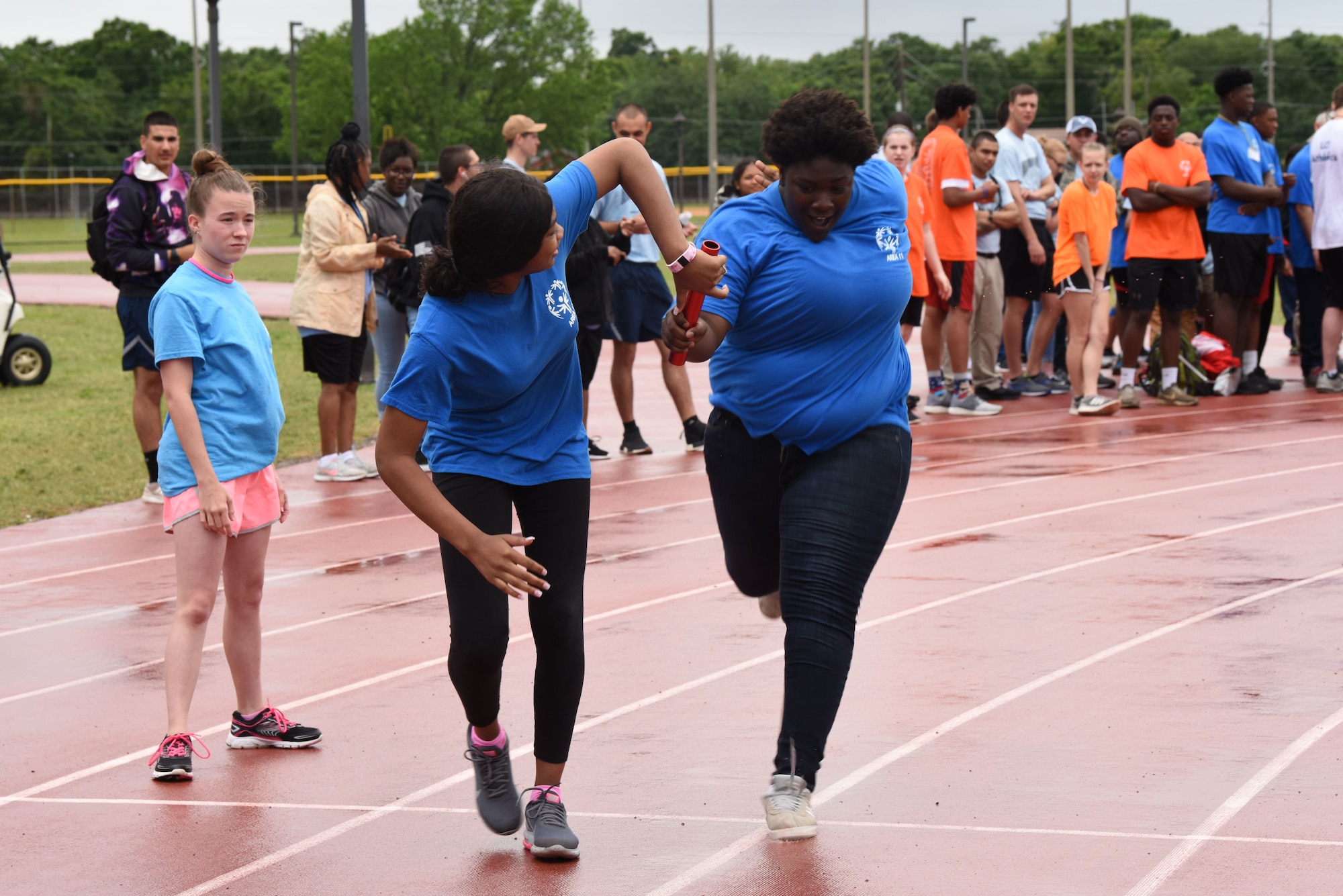 Serenity Stennis, Area 11 athlete, gets the baton to complete the 4x400 relay during the Special Olympics Mississippi 2019 Summer Games at Keelser Air Force Base, Mississippi, May 10, 2019. This is the first year that unified relays have been done during the Special Olympics Mississippi Summer Games. It is a product of a program that allows special olympics athletes and able-bodied athletes from local Mississippi high schools come together to compete in a 4x400 relay. (U.S. Air Force photo by Senior Airman Jenay Randolph)