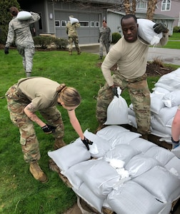New York Army and Air National Guard personnel conduct sandbagging operations near Sodus Point, N.Y. on May 7, 2019