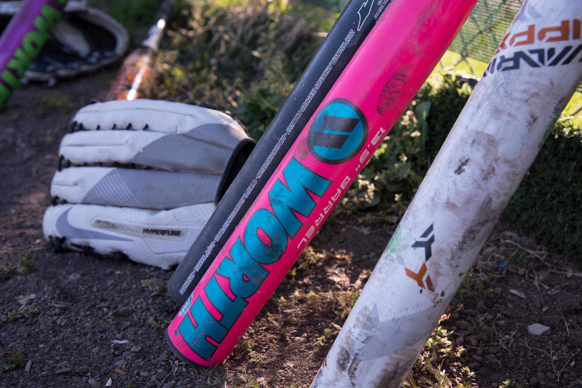 Softball equipment rests on a fence beside the dugout during a 2019 Cinco de Mayo softball tournament at Misawa Air Base, Japan, May 4, 2019. Five teams participated in the tournament supporting readiness and team cohesion. (U.S. Air Force photo by Branden Yamada)