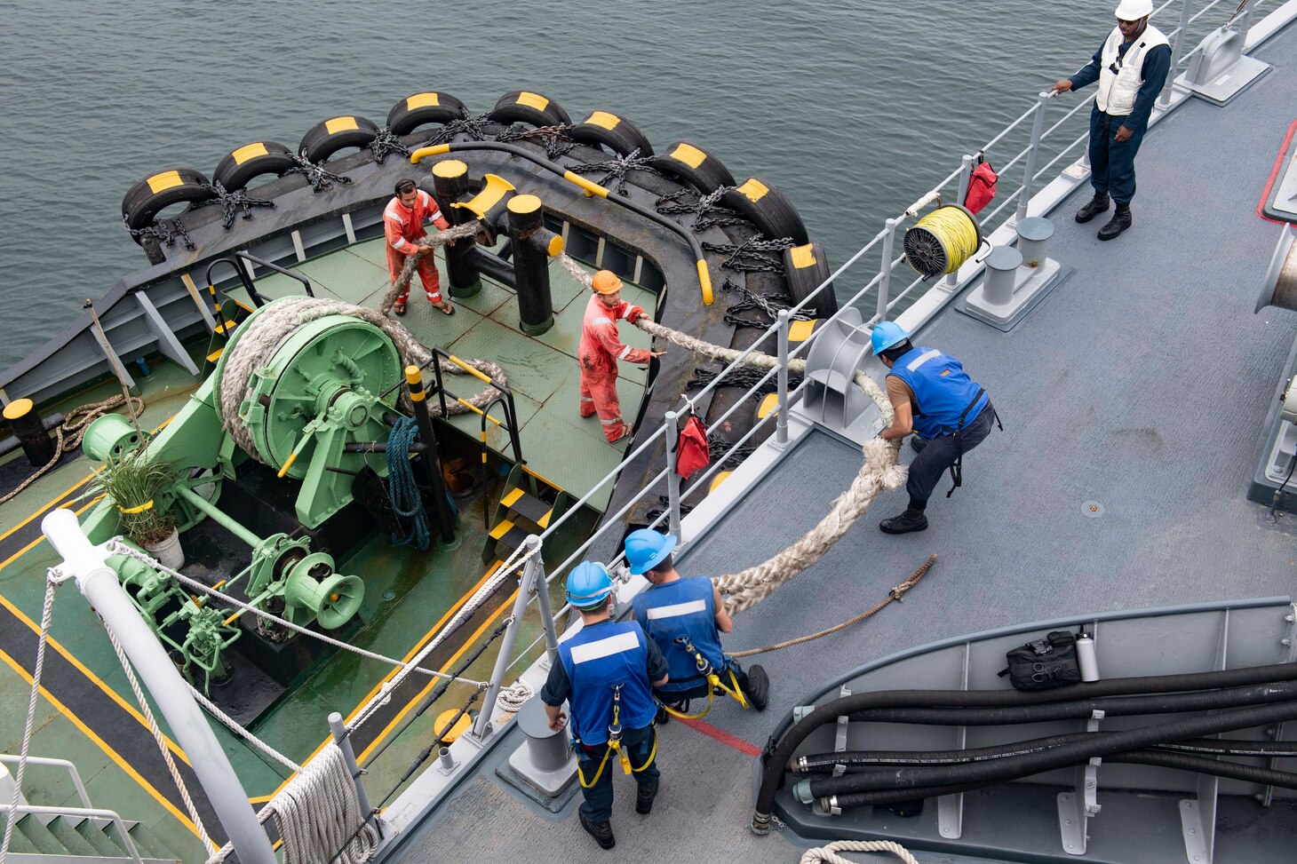 PUERTO PRINCESA, Republic of the Philippines (May 9, 2019) Sailors aboard the Avenger-class mine countermeasure ship USS Pioneer (MCM 9) attach lines from a tug while pulling into Puerto Princesa. Pioneer, part of Mine Countermeasures Squadron 7, is operating in the U.S. 7th Fleet area of operations to enhance interoperability with partners and serve as a ready-response platform for contingency operations.