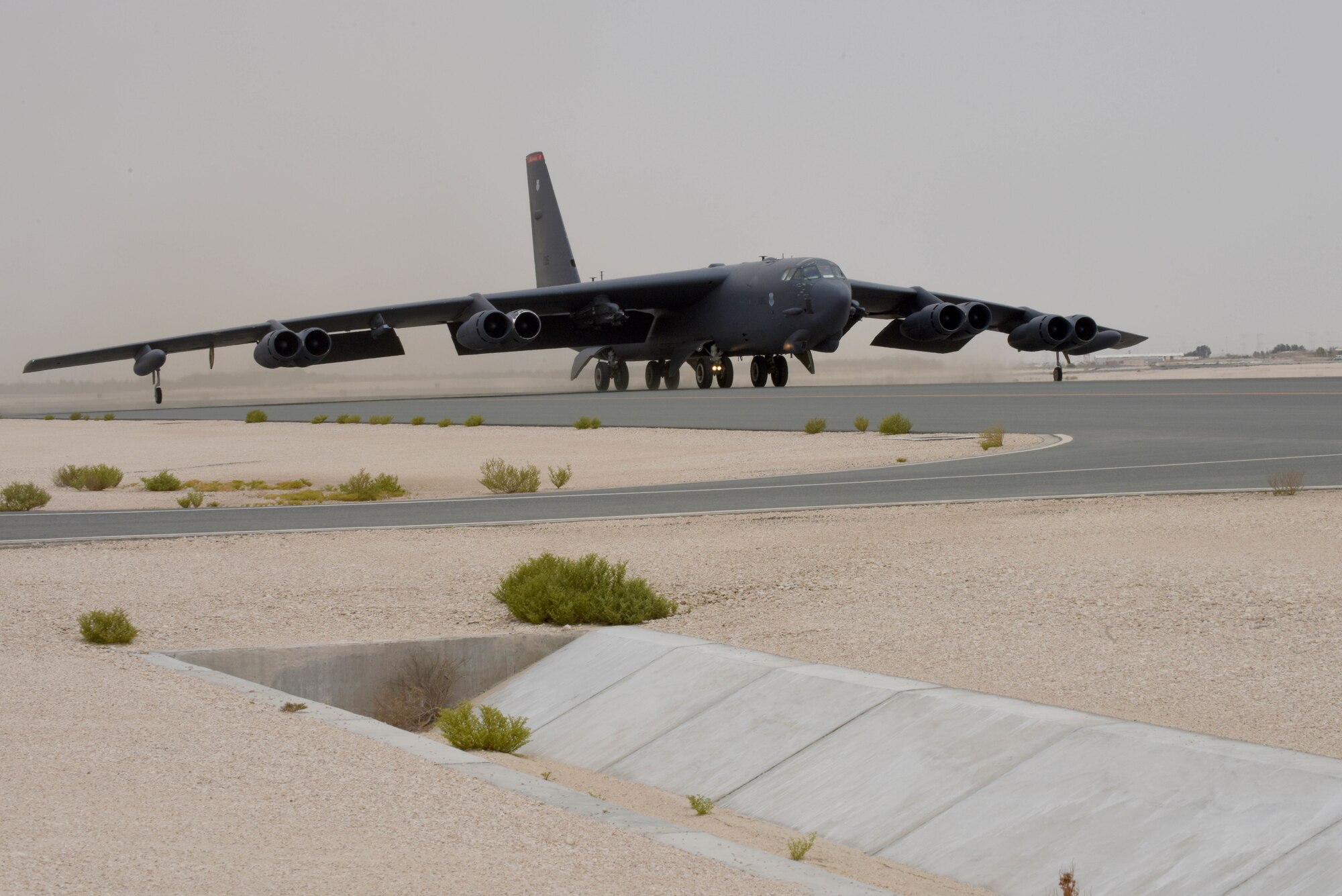 A photo of B-52 bomber taxiing on a runway.