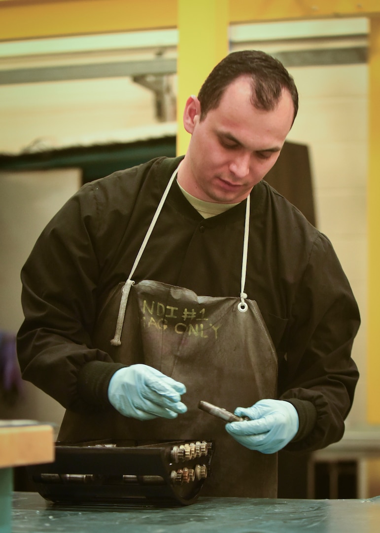 U.S. Air Force Tech. Sgt. Steven Izaguirre, 100th Maintenance Squadron NCO-in-charge of the non-destructive inspections, places bolts inside a slot guided inspection carriage at RAF Mildenhall, England, May 7, 2019. Izaguirre saves time during the bolt inspection process by utilizing the slot guided inspection carriage, which cut inspection times by 93 percent. (U.S. Air Force photo by Airman 1st Class Joseph Barron)