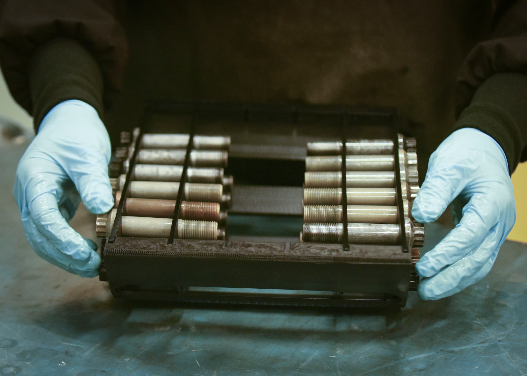 U.S. Air Force Tech. Sgt. Steven Izaguirre, 100th Maintenance Squadron NCO-in-charge of the non-destructive inspections, aligns bolts in a slot guided inspection carriage at RAF Mildenhall, England, May 7, 2019. Izaguirre and his Airmen inspect aircraft parts to ensure they are free of cracks and defects. (U.S. Air Force photo by Airman 1st Class Joseph Barron)