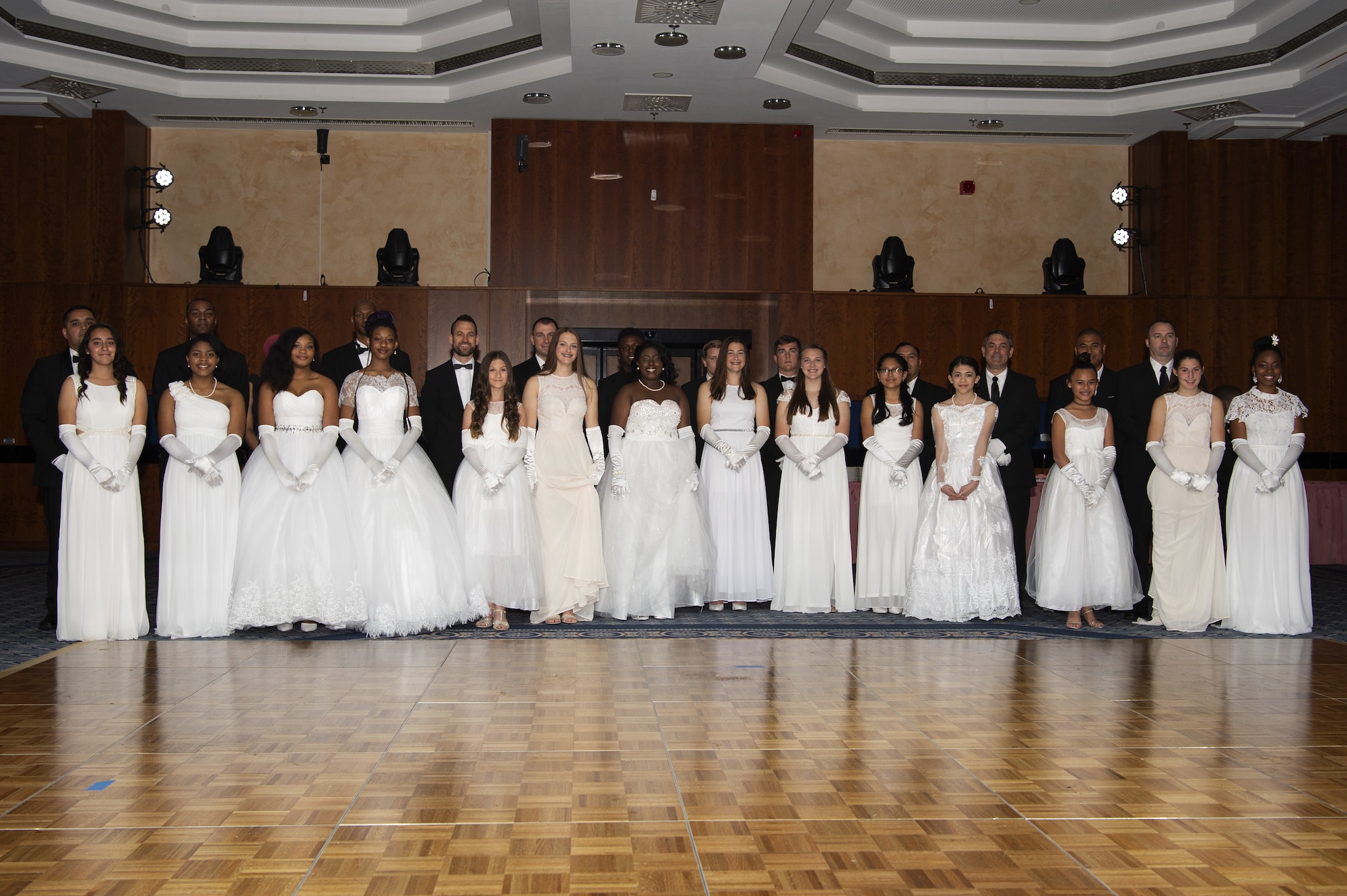 Spangdahlem High School and Middle School students, and their dates, pose for a photo during a banquet at Spangdahlem Air Base, Germany, May 10, 2019. The Preparing and Equipping Ambassadors to be Resilient Leaders program recognized high-performing students. (U.S. Air Force photo by Airman 1st Class Valerie Seelye)