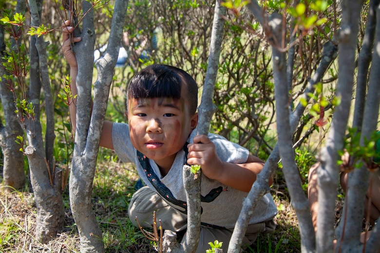 The local children play in the bushes during the Friendship Festival May 11, 2019, on Combined Arms Training Center Camp Fuji, Shizuoka, Japan. The local community, Japanese Ground Self-Defense Force, and U.S. service members experience a day dedicated to Japanese and Marine Corps tradition and culture events.