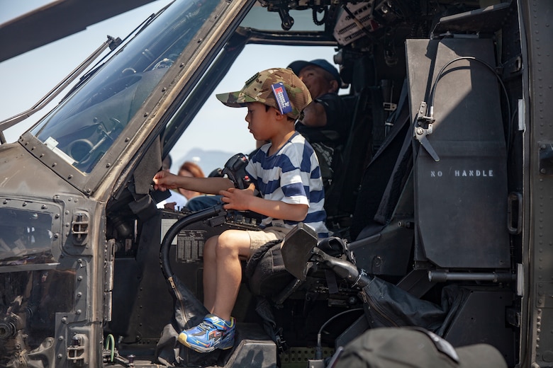 A local child explores the aircraft static display for the Friendship Festival May 11, 2019, on Combined Arms Training Center Camp Fuji, Shizuoka, Japan. The local community, Japanese Ground Self-Defense Force, and U.S. service members experience a day dedicated to Japanese and Marine Corps tradition and culture events.