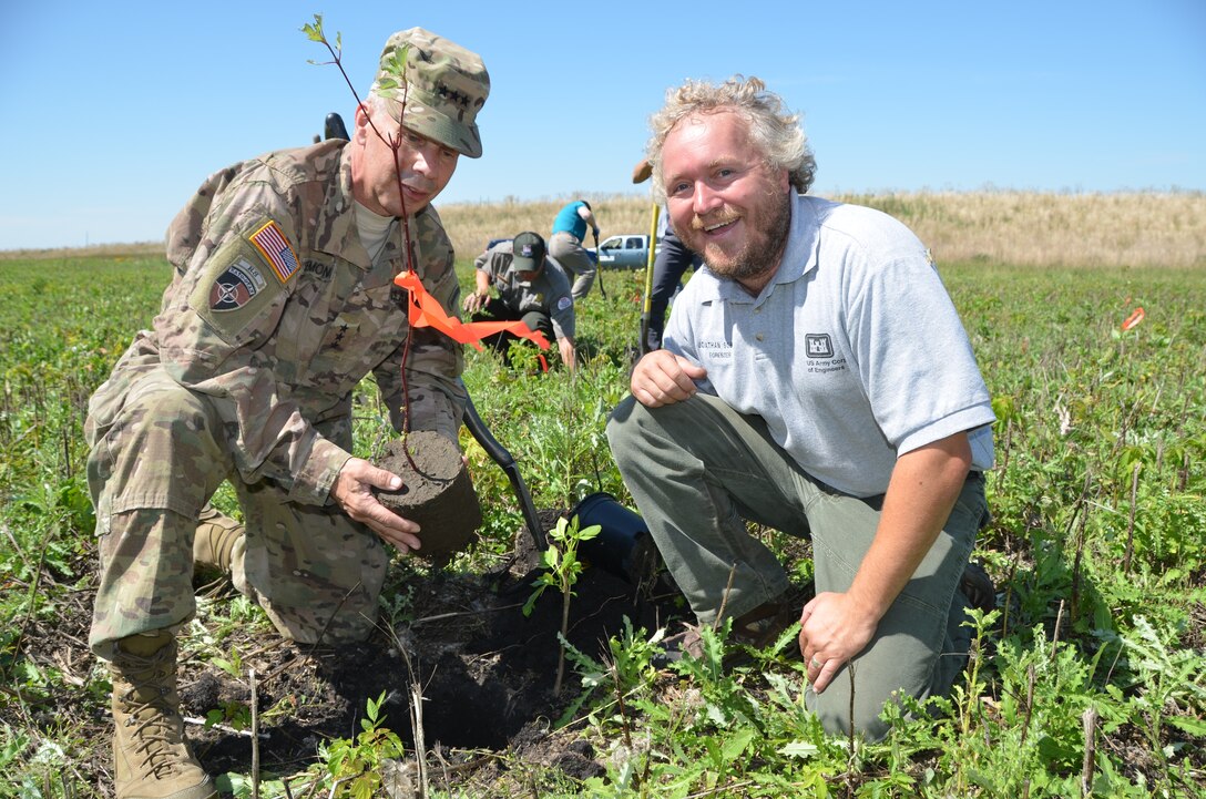 two men plant a tree