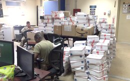 Sgt. Curtis Roach and Sgt. David Adkins, 184th Sustainment Command, sort and organize mail at Camp Arifjan, Kuwait, April 20, 2019. (Courtesy Photo)