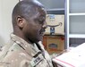 Sgt. Curtis Roach, 184th Sustainment Command, looks at a package at Camp Arifjan, Kuwait, April 29, 2019.