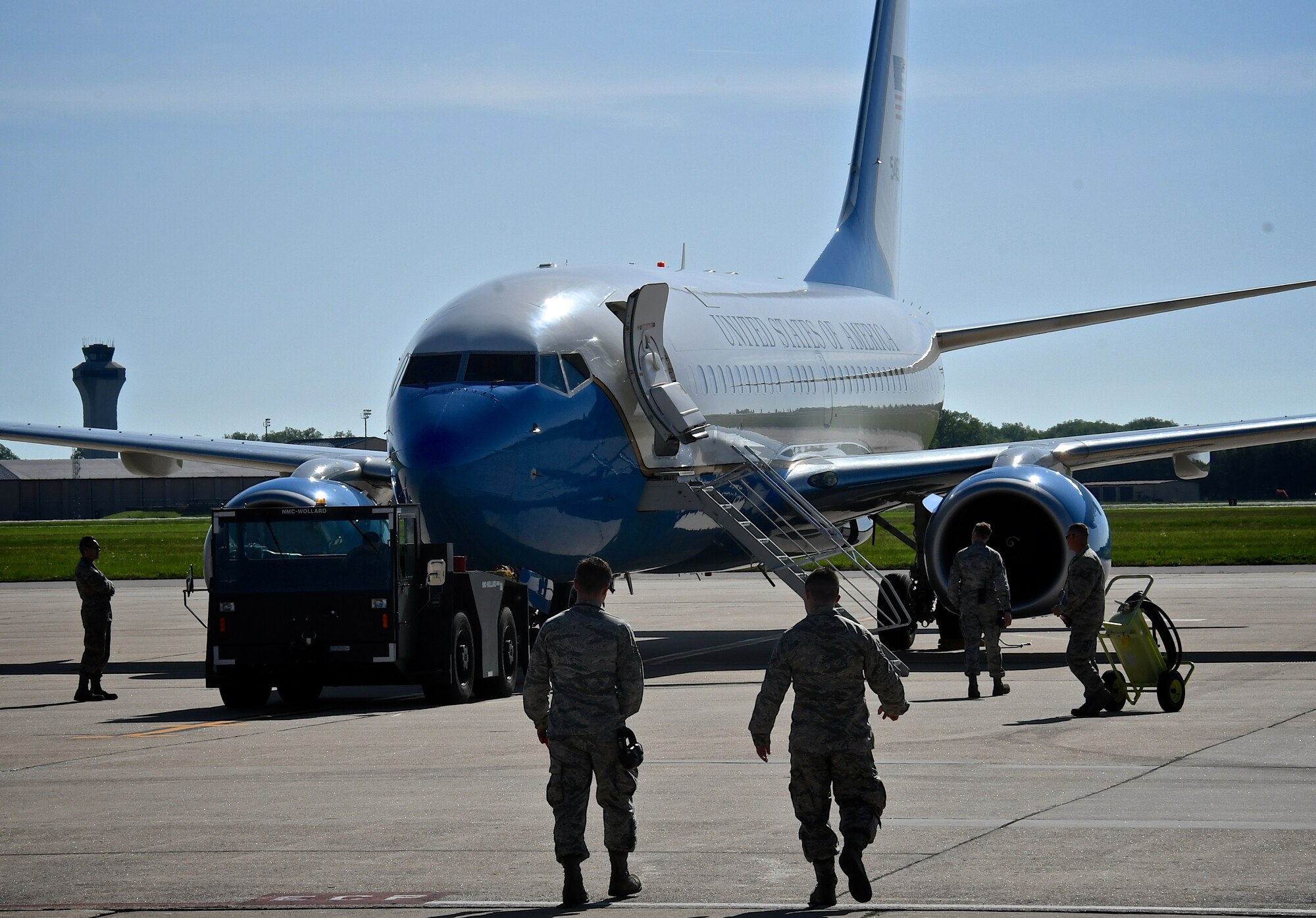 Airmen of the 932nd Maintenance Group move towing equipment toward a C-40C aircraft, to get it ready for another trip May 5, 2019, at Scott Air Force Base, Ill. All successful 932nd Airlift Wing C-40C mission launches start days earlier with mission planning, maintenance, and aircraft preparation. Another area behind the scenes that's important is keeping the ramps and parking spots clean and ready to launch missions. Time spent walking and getting eyes on the ramps protects tires and engines of all incoming and outgoing aircraft. This is done by manually collecting debris such as trash, blowing leaves, and small rocks or twigs, some dropped by birds flying over.  The 932nd Airlift Wing reservists maintain four of the unique C-40C planes.  (U.S. Air Force photo by Lt. Col. Stan Paregien)