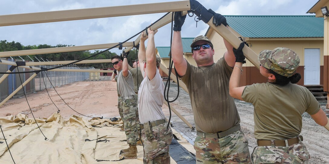U.S. Air Force Airmen assigned to the 52nd Combat Communications Squadron at Robins Air Force Base, Georgia, construct the communications tent during New Horizons exercise at Camp Seweyo, Guyana, May 11, 2019.