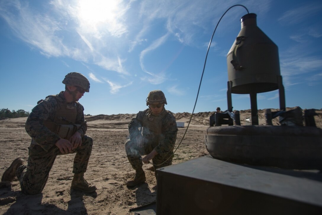 U.S. Marine Corps Cpl. Austin Brown and Pfc. Elias Cruz with Alpha Company, 8th Engineer Support Battalion, 2nd Marine Logistics Group trigger a 40 pound shape charge at Camp Lejeune, North Carolina, Feb. 7, 2019. Marines held the demolition familiarization range to sustain critical engineering knowledge and techniques. (U.S. Marine Corps photo by Lance Cpl. Scott R. Jenkins)