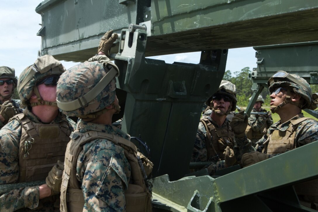 U.S. Marines with 8th Engineer Support Battalion, 2nd Marine Logistics Group, assemble a medium girder bridge at Camp Lejeune, North Carolina, May 2, 2019. 8th Engineer Support Battalion and Marine Heavy Helicopter Squadron 464 worked together to lift and move a medium girder bridge with a CH-53E Super Stallion to improve operational capabilities. (U.S. Marine Corps photo by Cpl. Damion Hatch Jr.)