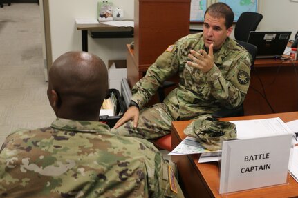 2nd Lt. Daniel Perez, a military intelligence officer assigned to the Headquarters Company, 50th Regional Support Group (RSG), discusses assignments to subordinate units with Staff Sgt. Nakia McCallum at the 50th RSG’s Emergency Operations Center in Homestead during the Florida National Guard’s annual hurricane readiness exercise. This was Perez’ first hurricane exercise since receiving his commission in 2018.