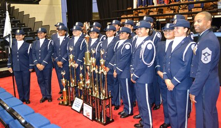 U.S. Air Force Chief Master Sgt. Jermaine Evans (right), Holm Center command chief, stands with the Silver Valor Air Force Junior Reserve Officer Training Corps cadets from Tom C. Clark High School, San Antonio, Texas, during the National High School Drill Team Competition May 3-5 2019, at Daytona Beach, Florida. Silver Valor won trophies for five events and placed second overall in the unarmed competition.