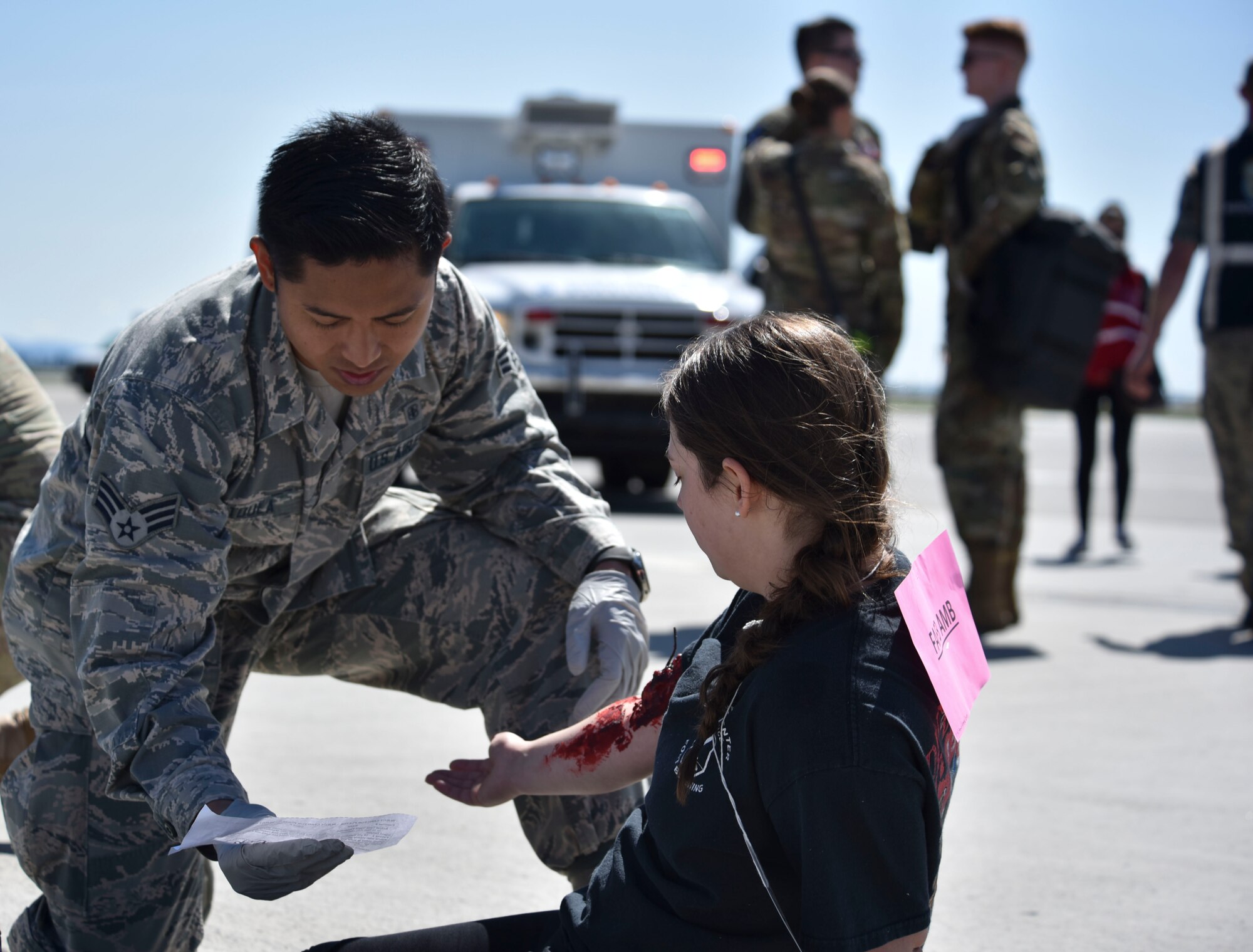 U.S. Air Force Senior Airman Urique Tatoula, 92nd Aerospace Medical Squadron operational medical technician, provides simulated medical care to Airman Kristine Bonch, 92nd Force Support Squadron fitness apprentice, during a Major Accident Response Exercise at Fairchild Air Force Base, Washington, May 9, 2019.