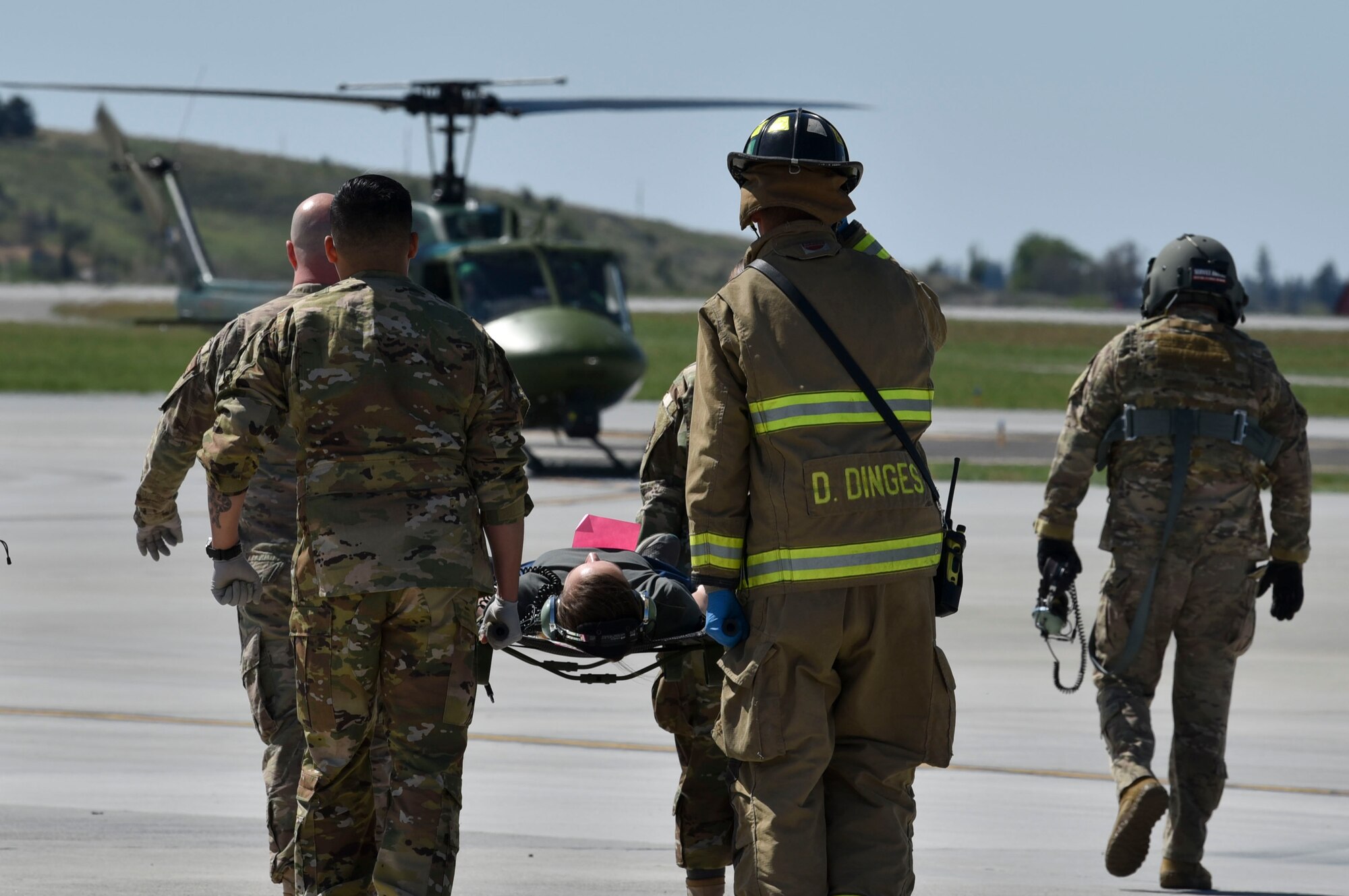 A Fairchild medical response team carries a fellow airman role-playing as an injured bystander during the Major Action Response Exercise at Fairchild Air Force Base, Washington, May 9, 2019.
