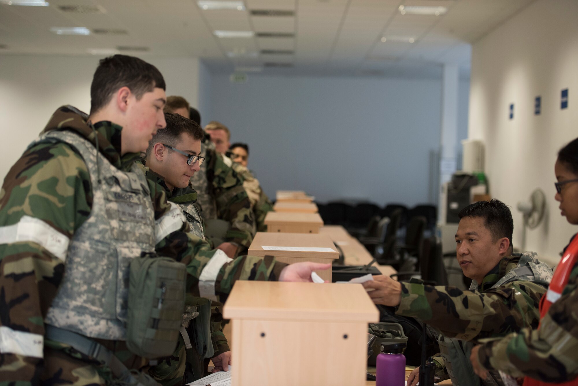 U.S. Air Force service members simulate large-scale personnel deployment processing through the Individual Deployment Readiness Center during Exercise Operation Varsity on Ramstein Air Base, Germany. The IDRC was facilitated during Exercise Operation Varsity to ensure the Ramstein mission could still be supported even in the midst of potentially catastrophic events. (U.S. Air Force photo by Senior Airman Kristof J. Rixmann)