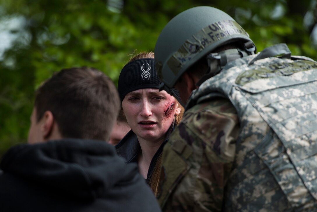A simulated traffic accident victim speaks to a U.S. Air Force Chaplain during Exercise Operation Varsity 19-02 on Ramstein Air Base, Germany, May, 10, 2019. The 86th Airlift Wing Chaplain Corps supported injured members before they were transported to medical treatment facilities. (U.S. Air Force photo by Senior Airman Devin M. Rumbaugh)