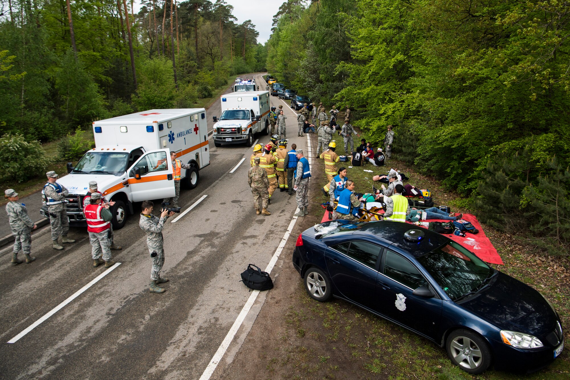 First responders assigned to the 86th Airlift Wing stabilize simulated traffic accident victims during Exercise Operation Varsity 19-02 on Ramstein Air Base, Germany, May 10, 2019. The mass casualty exercise tested response capabilities of the 86th Medical Group, 86th Security Forces, 86th Airlift Wing Chaplain Corps, and many other base agencies. (U.S. Air Force photo by Senior Airman Devin M. Rumbaugh)