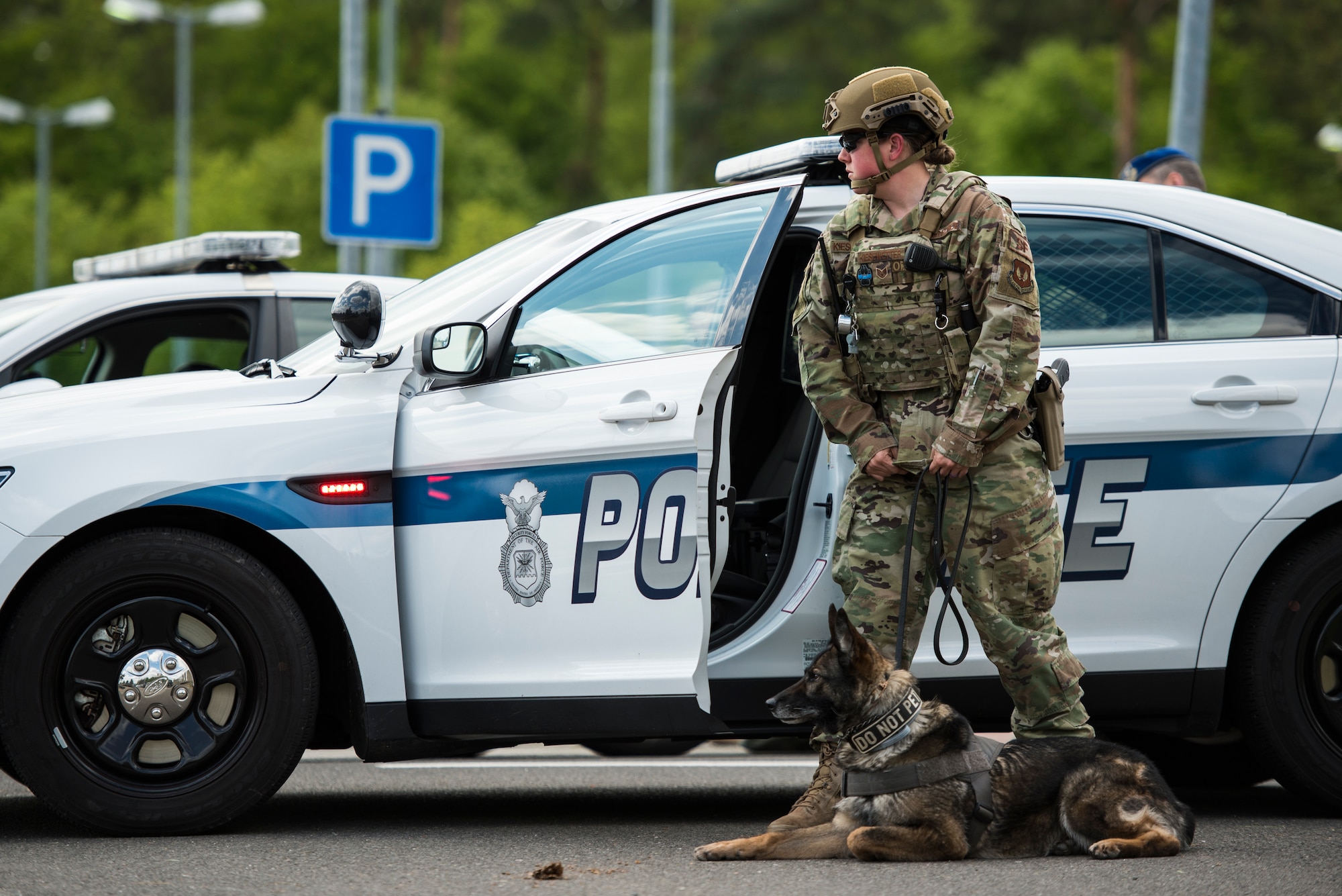 An 86th Security Forces Squadron K-9 Handler and her K-9 stand ready during Exercise Operation Varsity 19-02 on Ramstein Air Base, Germany, May 7, 2019. The 86th SFS responded to several threats, including suspects running gates and planting suspicious packages. (U.S. Air Force photo by Senior Airman Devin M. Rumbaugh)