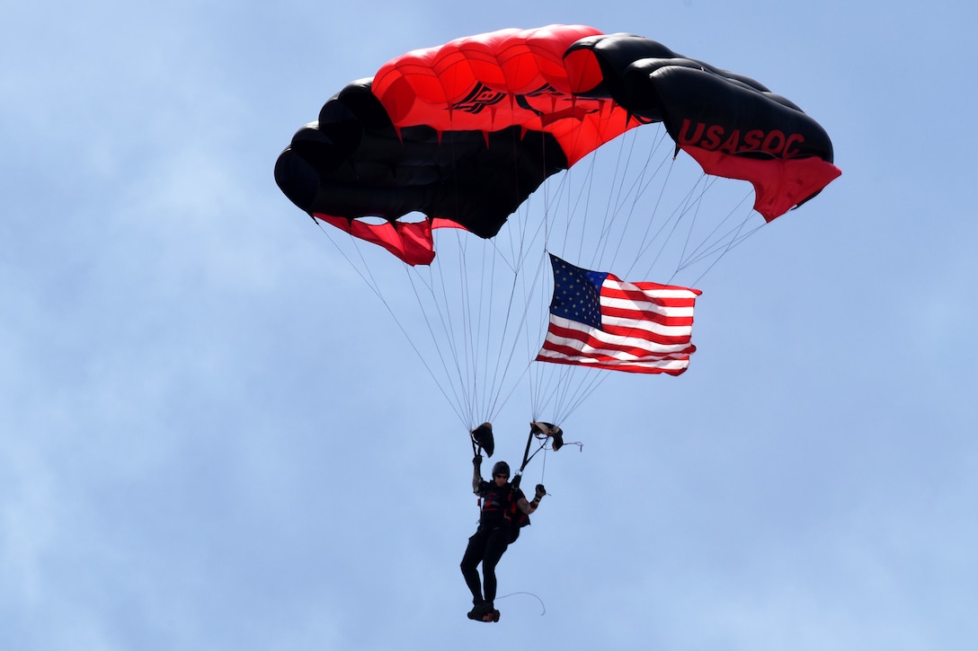 A solider parachutes during a performance.