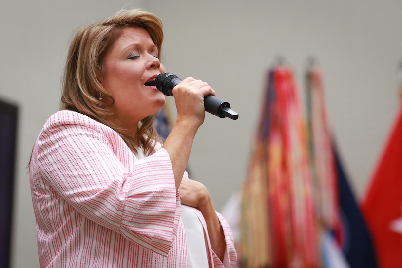 Emily Martuscelli, a vocalist from Alice Drive Baptist Church in Sumter, South Carolina, sings a worship song during the National Day of Prayer luncheon at U.S. Army Central headquarters on Shaw Air Force Base, S.C., May 2, 2019.