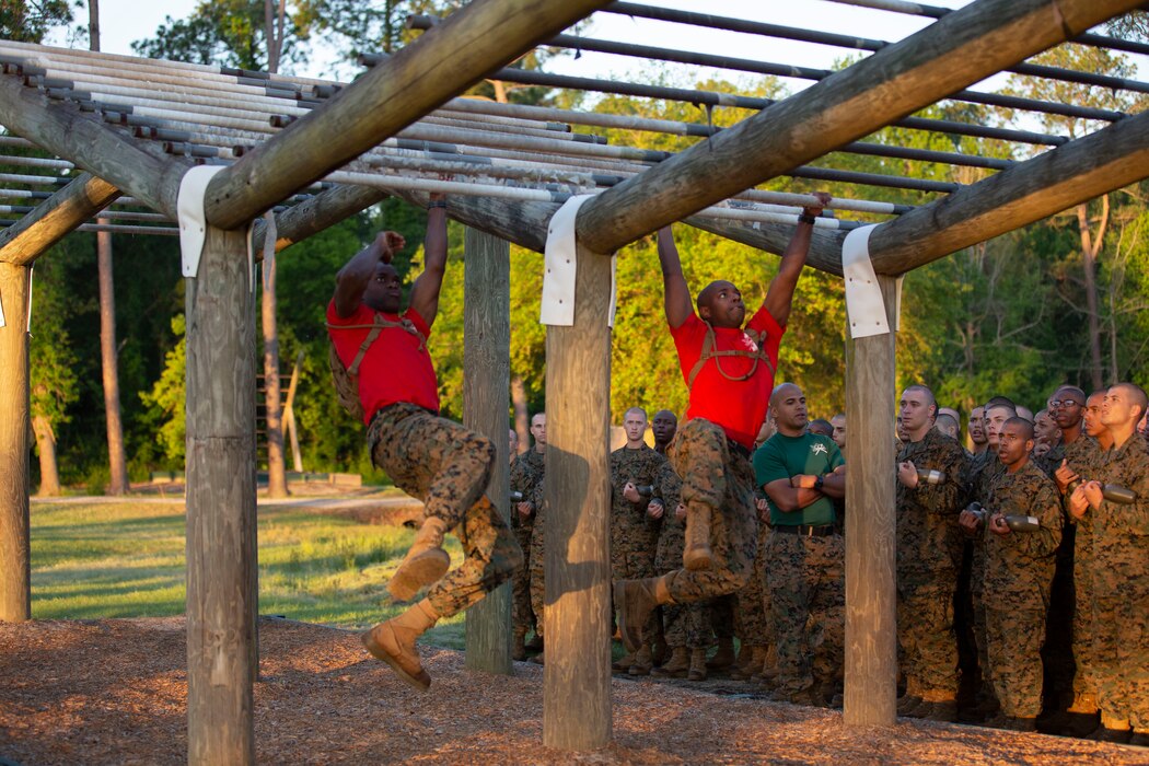 Drill Instructors with Alpha Company, 1st Recruit Training Battalion demonstrate an obstacle for recruits during the Confidence Course at Leatherneck Square on Parris Island S.C., April 23, 2019. The course is comprised of 15 obstacles designed to help recruits build confidence by overcoming physical and mental challenges. Parris Island has been the site of Marine Corps recruit training since Nov. 1, 1915. Today, approximately 19,000 recruits come to Parris Island annually for the chance to become United States Marines by enduring 13 weeks of rigorous, transformative training. Parris Island is home to entry-level enlisted training for approximately 49 percent of male recruits and 100 percent of female recruits in the Marine Corps. (U.S. Marine Corps photo by Cpl. Isabella Ortega/Released)
