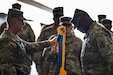 Members from the 35th Combat Aviation Brigade, Missouri Army National Guard, and the 244th Expeditionary Combat Aviation Brigade, U.S. Army Reserve, salute the colors during a transfer of authority ceremony in an aircraft hangar in Taji, Iraq, May 1, 2019.  The 35th CAB and 244th ECAB support Combined Joint Task Force – Operation Inherent Resolve and Operation Spartan Shield.  CJTF-OIR works with partner forces to defeat Daesh in designated areas and set conditions for follow-on operations to increase regional stability.