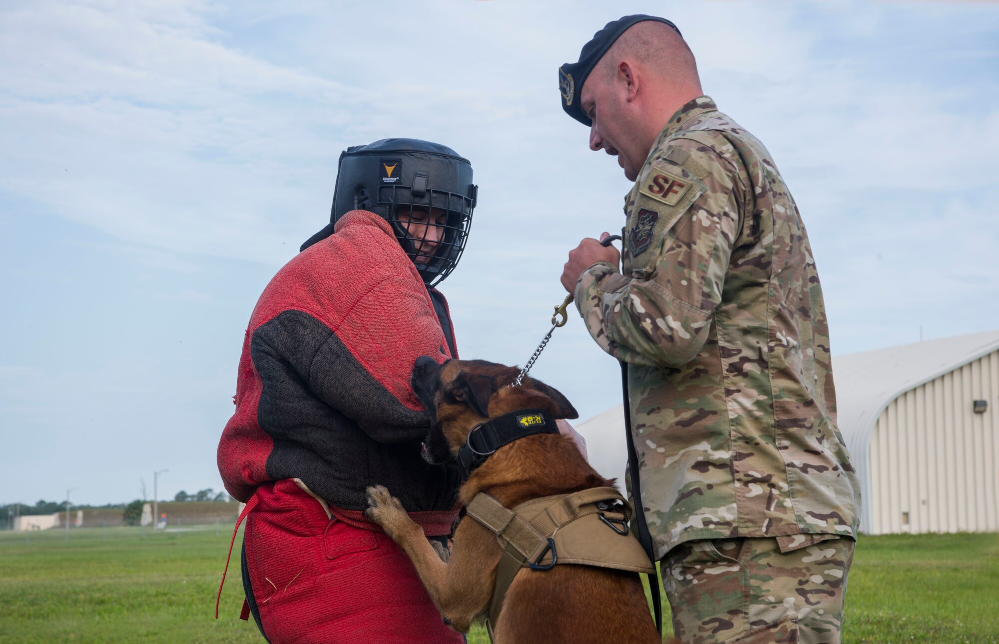 Tech. Sgt. Josue Silva, an 18th Air Force (AF) enlisted aide from Scott Air Force Base, Ill., participates in a bite training exercise with Tech. Sgt. Matthew McElyea, the 6th Security Forces Squadron kennel master, and his log, Lleonard, at MacDill AFB, Fla., May 9, 2019.