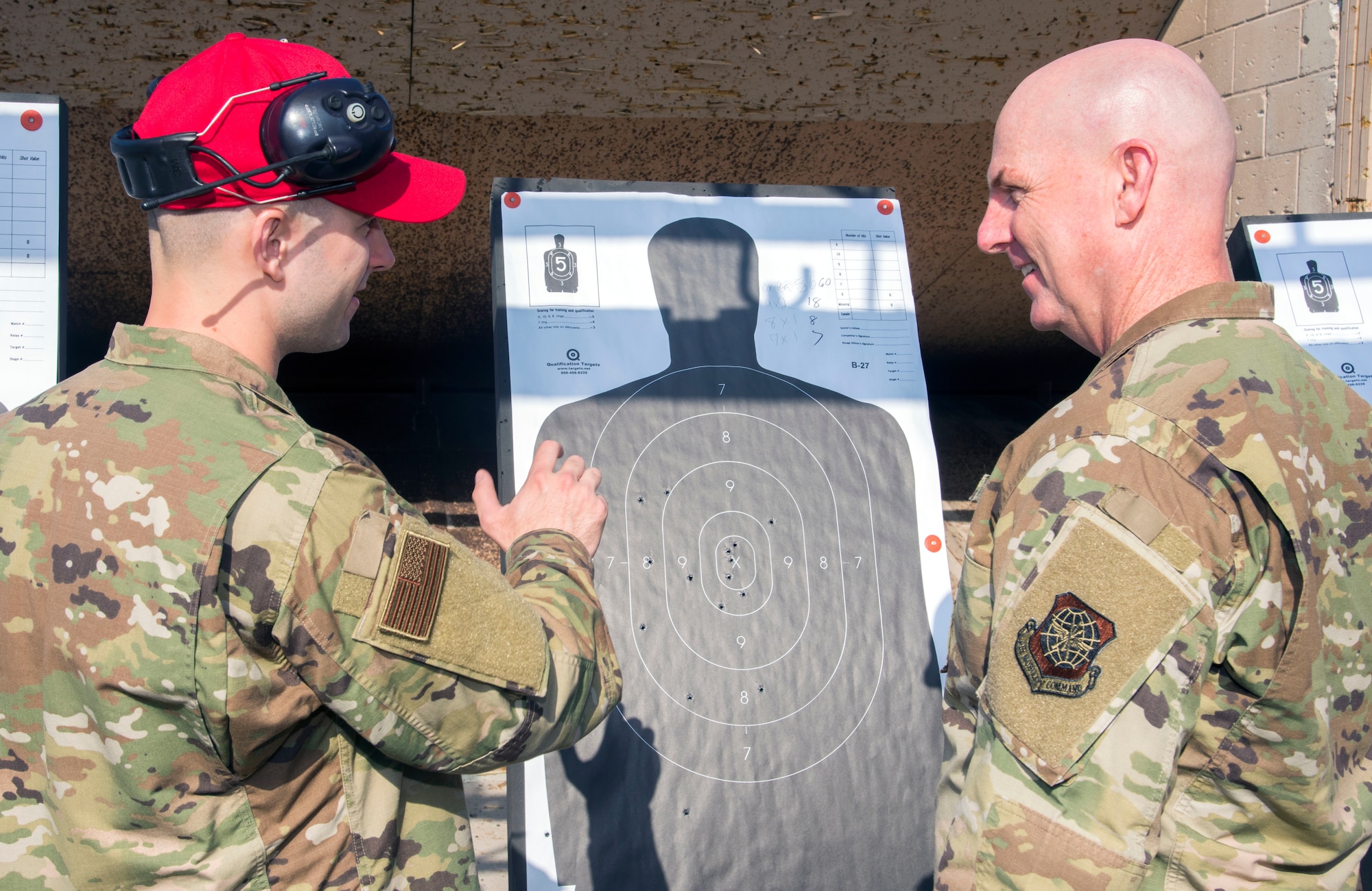 U.S. Air Force (USAF) Maj. Gen. Sam Barrett, the 18th Air Force commander from Scott Air Force Base, Ill., talks about M-9 pistol qualification with USAF Staff Sgt. Dalhian Guest, a 6th Security Forces Squadron combat arms instructor, at MacDill AFB, Fla., May 9, 2019.