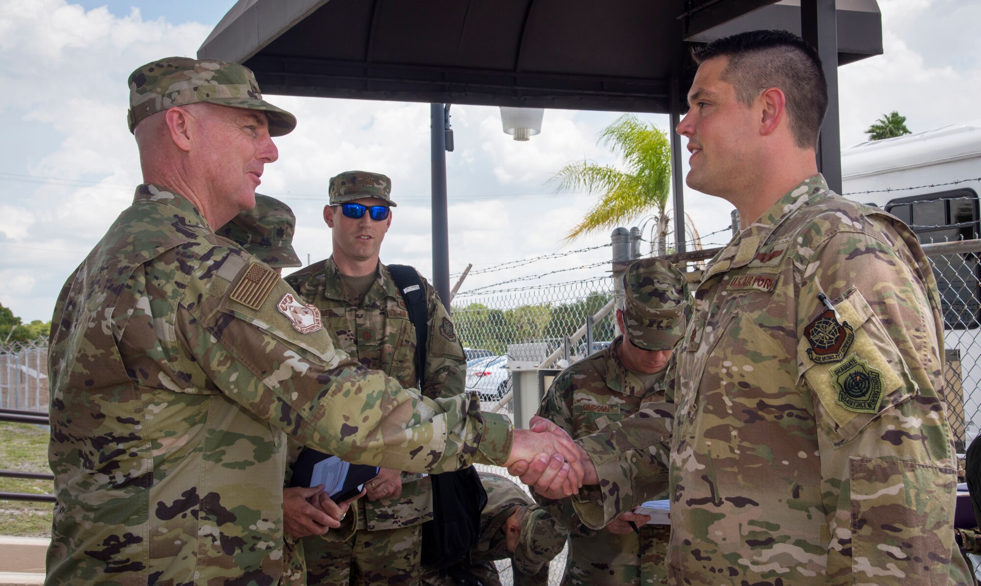 U.S. Air Force Maj. Gen. Sam Barrett, the 18th Air Force commander from Scott Air Force Base, Ill., coins Maj. Benjamin Hedges, the 6th Operations Support Squadron combat support flight commander, at MacDill AFB, Fla., May 9, 2019.