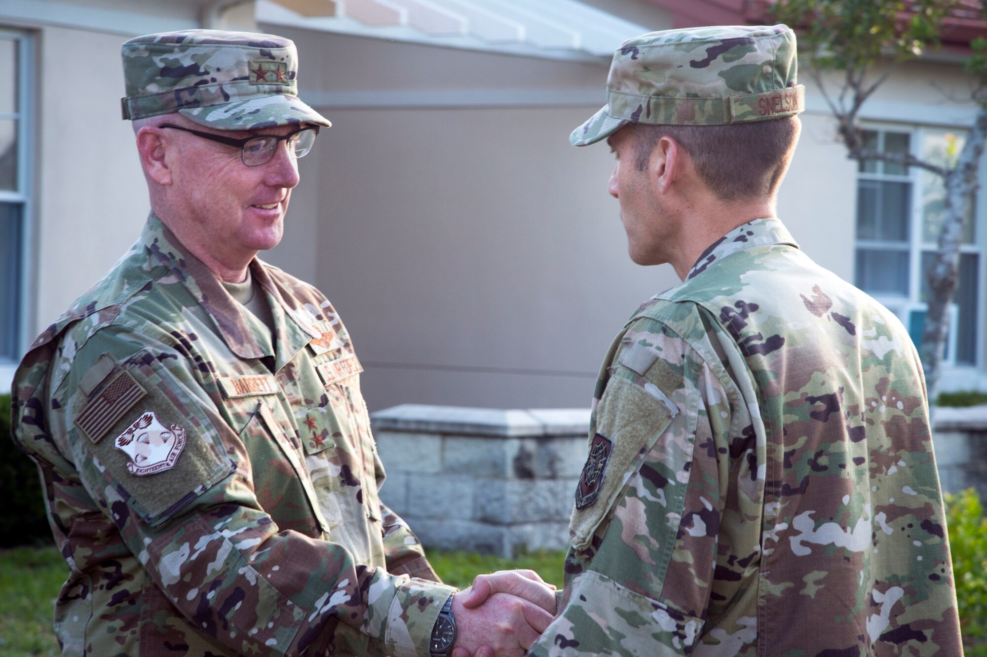 U.S. Air Force Col. Stephen Snelson, right, the 6th Air Mobility Wing commander, greets Maj. Gen. Sam Barrett, left, the 18th Air Force (AF) commander from Scott Air Force Base, Ill., at MacDill AFB, Fla., May 7, 2019.