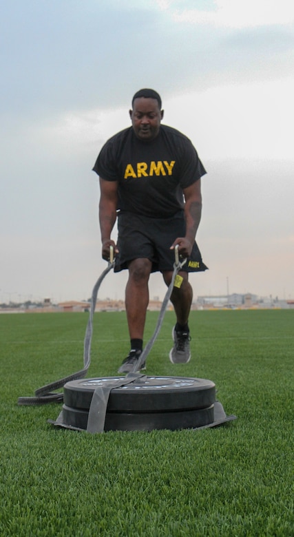Sergeant 1st Class Jarod Gatson, communications noncommissioned officer in charge, Headquarters and Headquarters Company, 1st Battalion, 114th Infantry Regiment, prepares for the drag portion of the sprint-drag-carry Army Combat Fitness Test event during a familiarization training at Camp As Sayliyah, Qatar, May 4, 2019.