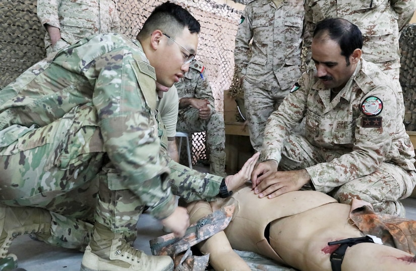 Spc. Jay Choi, left, a medic with the 64th Brigade Support Battalion, 3rd Armored Brigade Combat Team, 4th Infantry Division, Task Force Spartan, works with soldiers from the Kuwaiti Land Forces 11th Engineer Battalion to conduct medical training at Camp Buehring, Kuwait, on April 3, 2019. Choi said he enjoyed working with the KLF Soldiers on developing basic combat lifesaver skills and getting the opportunity to see how other forces are trained.